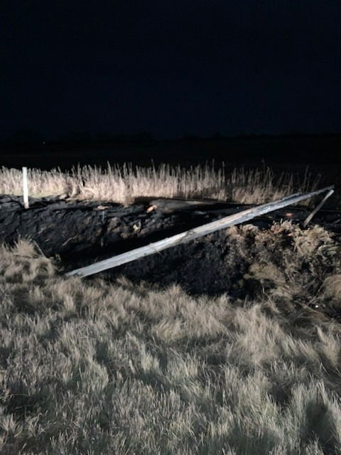 power pole laying in ditch after being hit by car