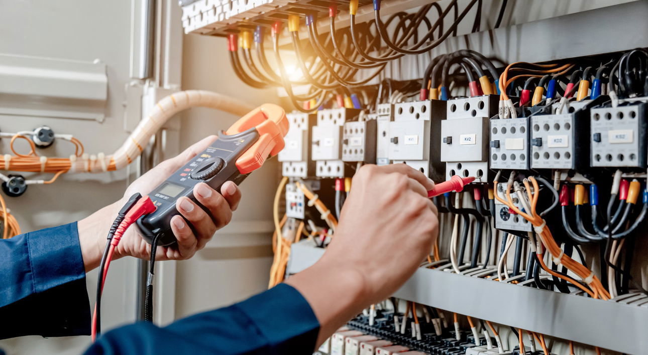 Electrician tests electrical panel