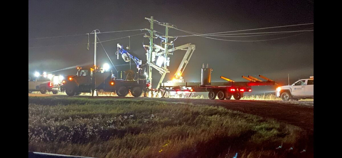 Repair truck and crew make repairs at night